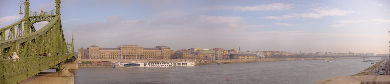 a bridge over a river with a boat in the water